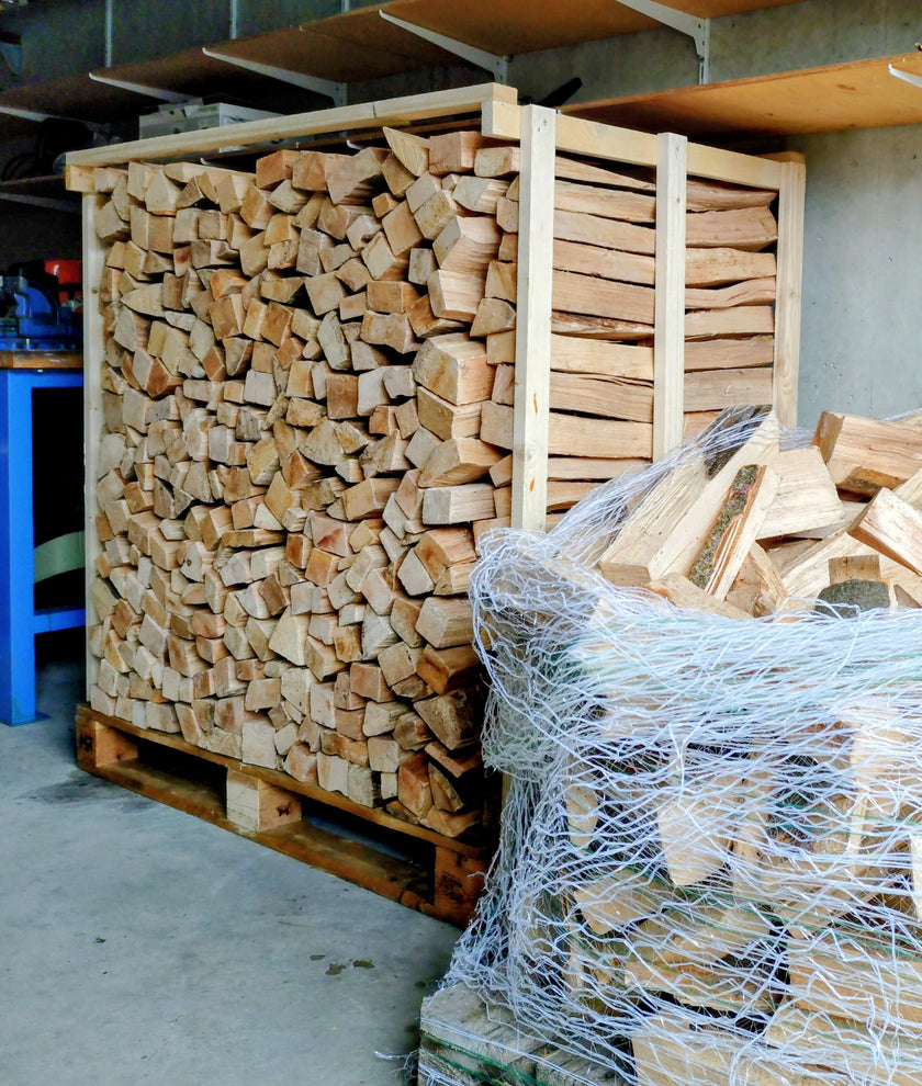 Beech firewood stacked in a wooden crate on a pallet